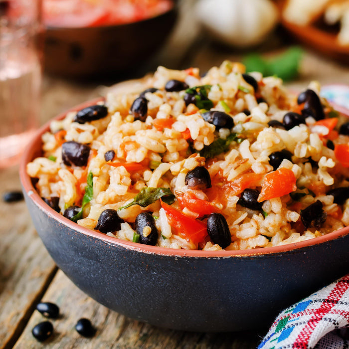 Prepared black bean and rice dish served in a clay bowl, made with Emergency Essentials Black Beans