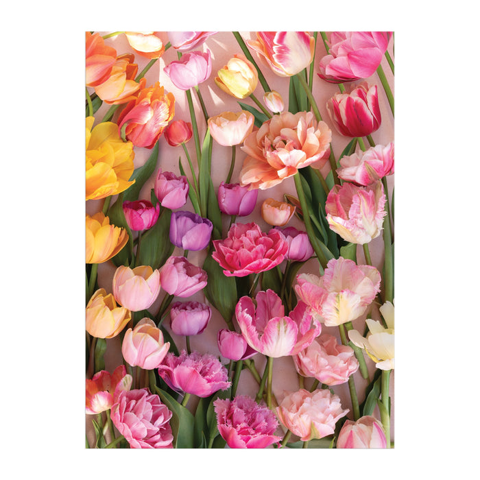 The Ephemeral Tulips 1000 Piece Puzzle by Christine Chitnis features a vibrant array of tulips with lush green leaves against a soft background, beautifully captured in an eco-friendly design.