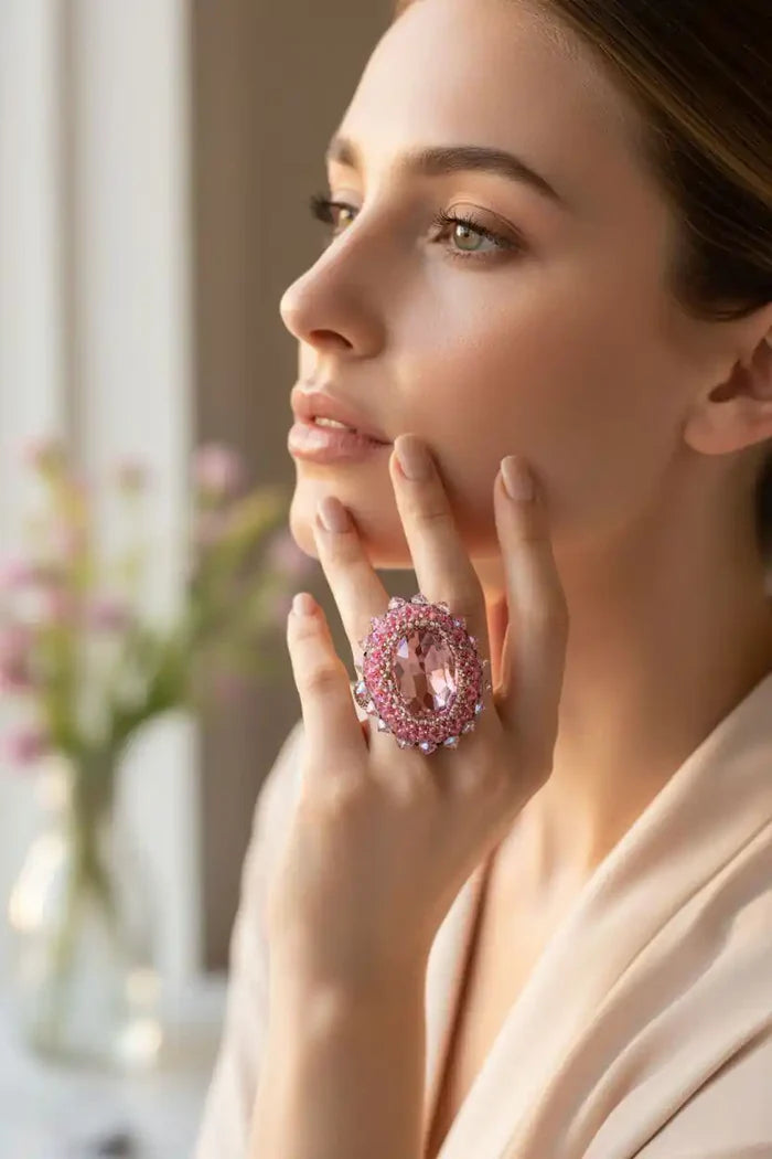 Woman showcasing Epic Beaded Rose Crystal Bling Cocktail Ring with pink crystals and elegant design.