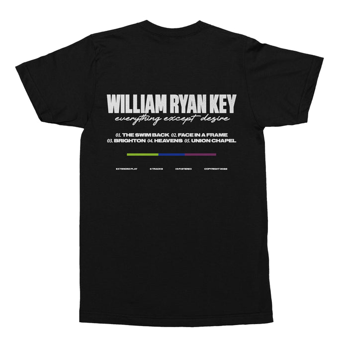 Back of black short sleeve shirt. There is large white text that says WILLIAM RYAN KEY. Underneath that, there is cursive lettering that says EVERYTHING EXCEPT DESIRE. Below that is a numbered track list. Below that, there is a color blocked line, of green, dark blue, and purple.