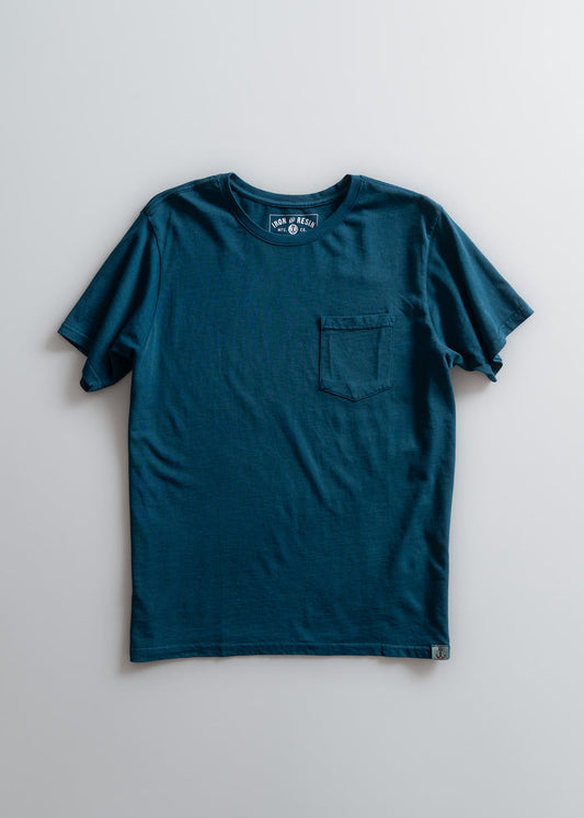 Blue t-shirt with a chest pocket, displayed on a plain background. The label reads "Iron & Resin." Simple and classic design.