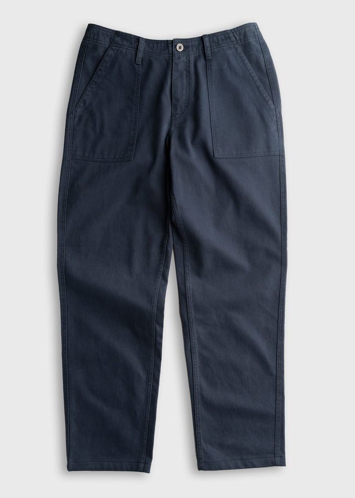 Dark blue pants with front pockets and a button closure, laid flat on a light background, showcasing casual style and design.