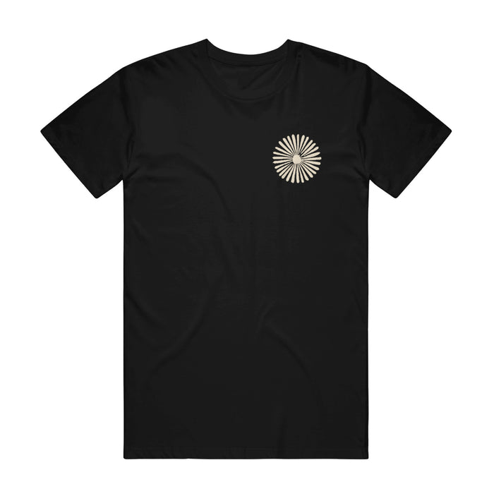 Black t shirt against white background. Front of shirt has a beige circle design on upper right corner.
