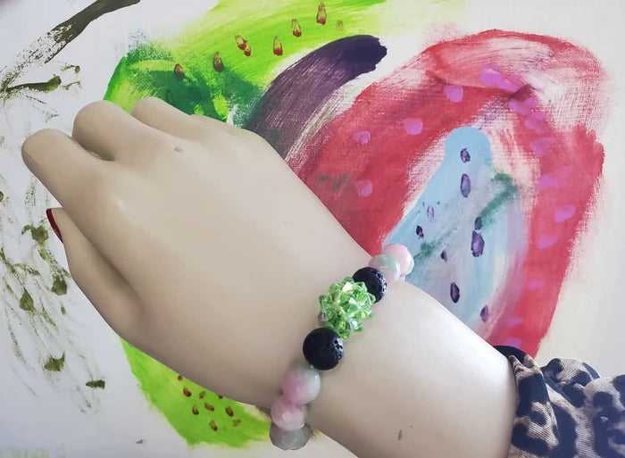 Gem Packed Watermelon Jade Crystal Lava Rock Bracelet showcased on a mannequin hand with vibrant colorful background.