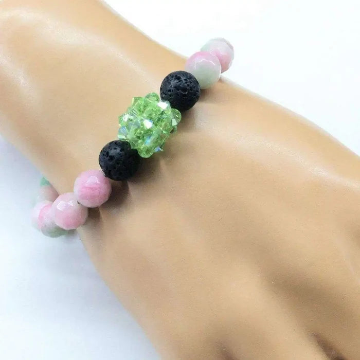 Gem Packed Watermelon Jade Crystal Lava Rock Bracelet featuring pink jade and lava rock beads on a model's wrist.