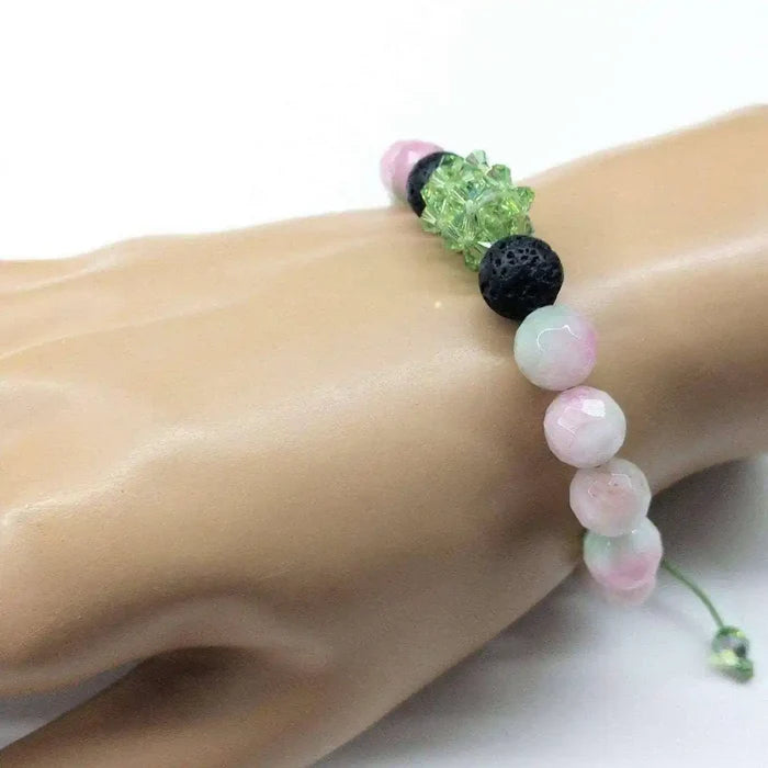 Gem Packed Watermelon Jade Crystal Lava Rock Bracelet showcasing pink and black beads on a hand model.