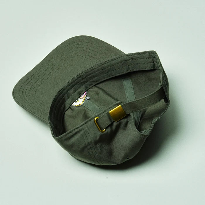 Green cap with a logo and buckle on a light gray background