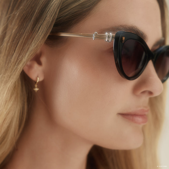 on model - blonde female wearing diff eyewear x practical magic 2 gillian cateye sunglasses with a black frame and purple gradient lenses detailed view