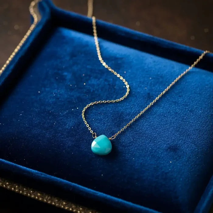 Gold Filled Aqua Jade Wire Wrap Gemstone Drop Necklace on a blue velvet background.