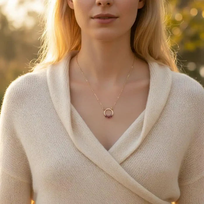 Gold Filled Pink Chalcedony Open Circle Necklace worn by a woman in a cozy sweater, highlighting the elegant design.