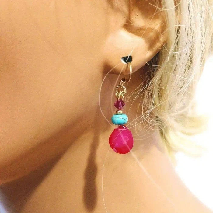 Gold Filled Wire Wrapped Pink And Aqua Gemstone Earrings displayed on an earring stand, showcasing vibrant colors.