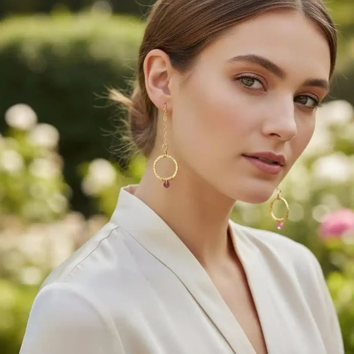 Gold Filled Wrapped Pink Chalcedony Open Circle Earrings worn by a model in a garden setting.