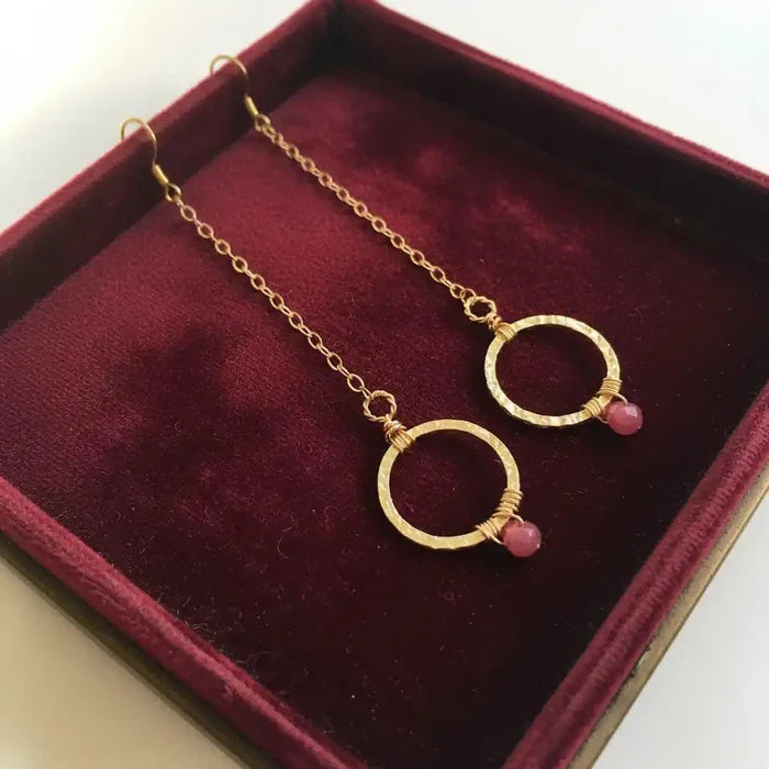 Gold Filled Wrapped Pink Chalcedony Open Circle Earrings displayed in a stylish jewelry box with maroon velvet.