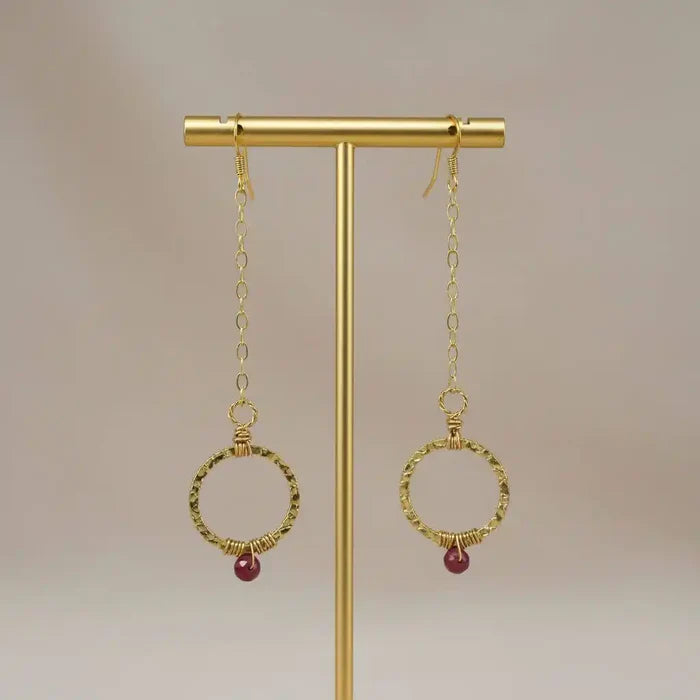 Gold Filled Wrapped Pink Chalcedony Open Circle Earrings hanging on display stand.