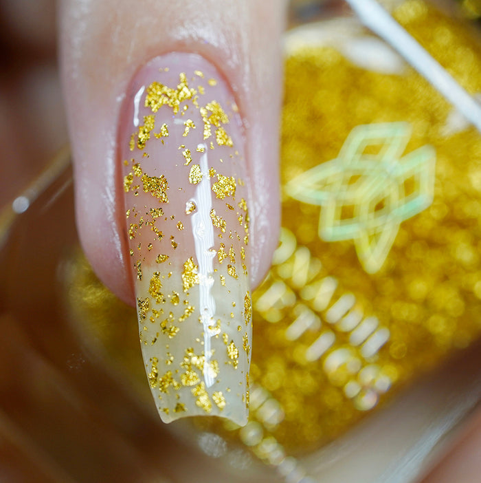 Close up shot of one long nail done with Golden Prairie Nail Lacquer on fair skin tone.