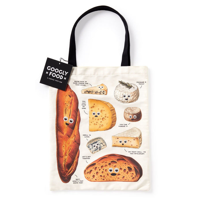 The Googly Food Canvas Tote by Brass Monkey features cartoon cheeses and breads with googly eyes and funny labels, black handles, and a tag reading Googly Food: A Canvas Tote Bag—perfect for adding foodie flair.