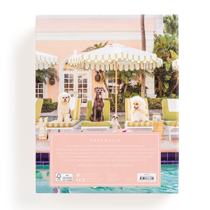 Four dogs lounge poolside under a striped umbrella in this playful Gray Malin Pool Day Palm Beach 1000 Piece Book Box Puzzle, evoking The Colony Hotel’s pastel charm and classic Palm Beach style.