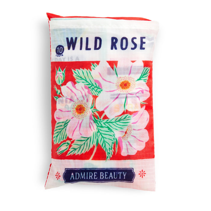 A red and white reusable nylon tote bag by Emily Taylor, labeled Grow Your Own Way, features pink wild rose flowers, green leaves, 10 Tins at the top left, and Admire Beauty in a purple box. Eco-friendly and packable.