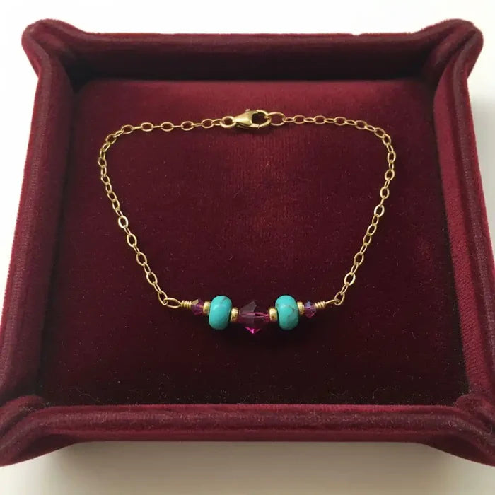 Handmade Gold Filled Pink Turquoise Gemstone Bracelet featuring turquoise beads and fuchsia crystals on a gold chain.