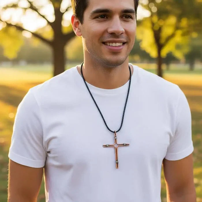 Handmade Large Copper and Silver Wire Cross Necklace for Men worn by a man in a white shirt outdoors during sunset.