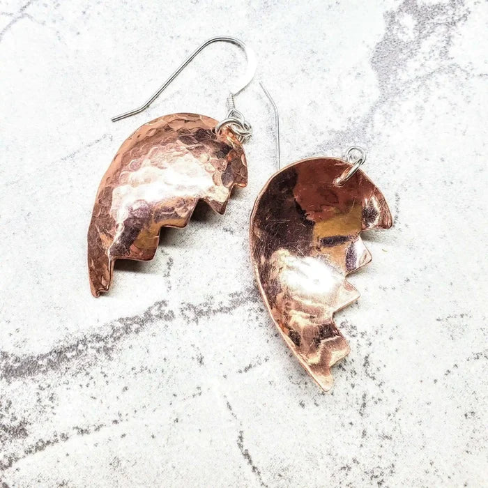 Handmade Sculpted Copper Broken Heart Earrings showcasing artisan metalwork in a unique design.