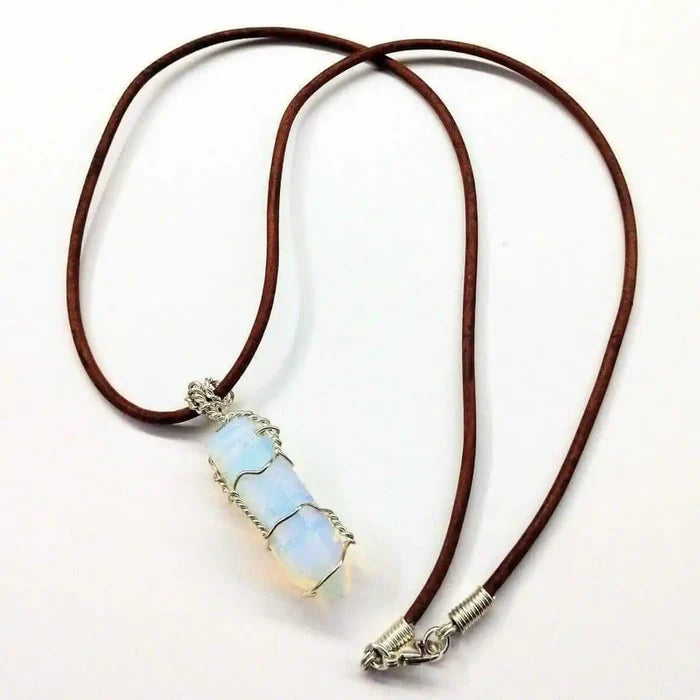 Handmade Silver Wire Wrapped Gemstone Crystal Point Pendant on a leather cord, showcasing its unique beauty and craftsmanship.