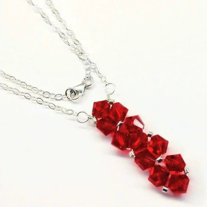 Handmade Wire Colored Woven Crystal Rock Candy Necklace featuring red Swarovski crystal bicones on a silver chain.