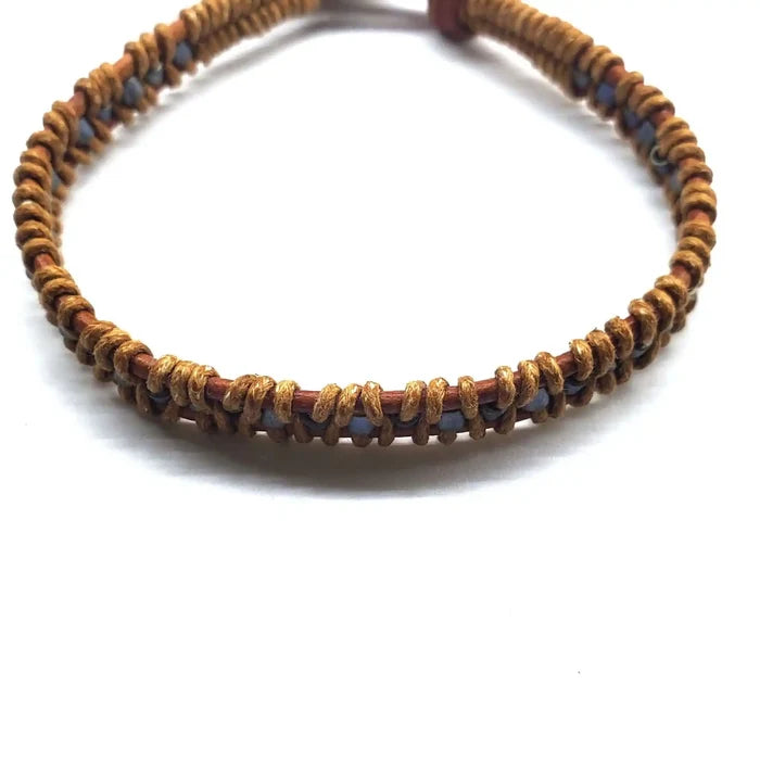Handmade Tree of Life leather wrap bracelet featuring earthy brown and gray seed beads, handcrafted in Montana.