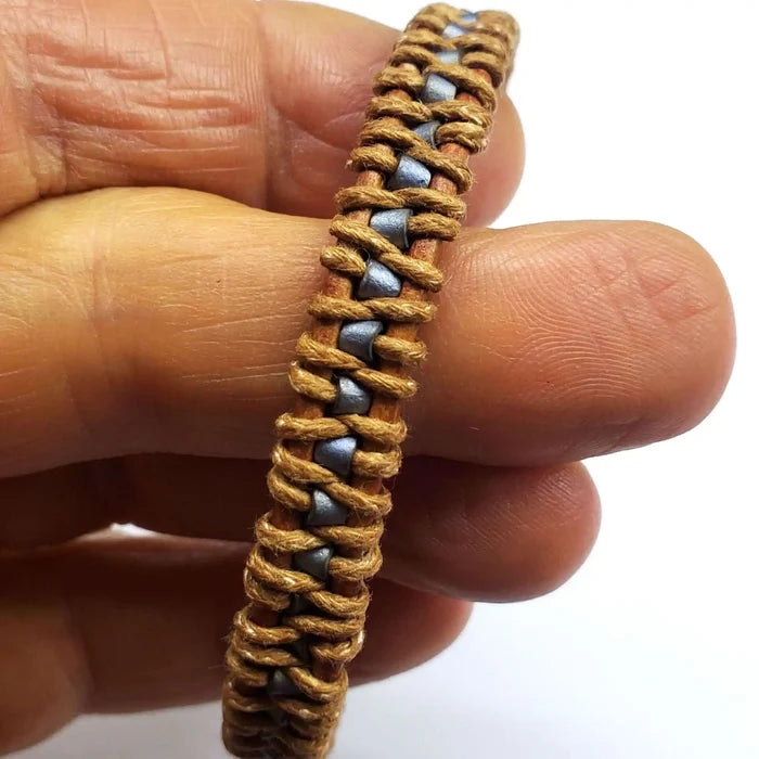 Handmade Tree of Life leather wrap bracelet showcasing brown and gray seed beads in a unique design.