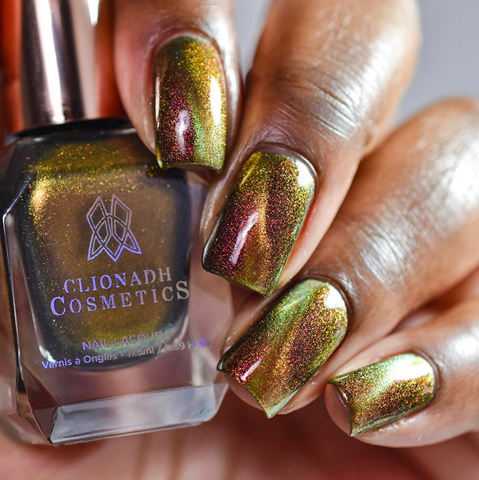 Close up of nails done with Hazard Nail Lacquer featuring a design to show off the magnetic effecton deep skin tone.