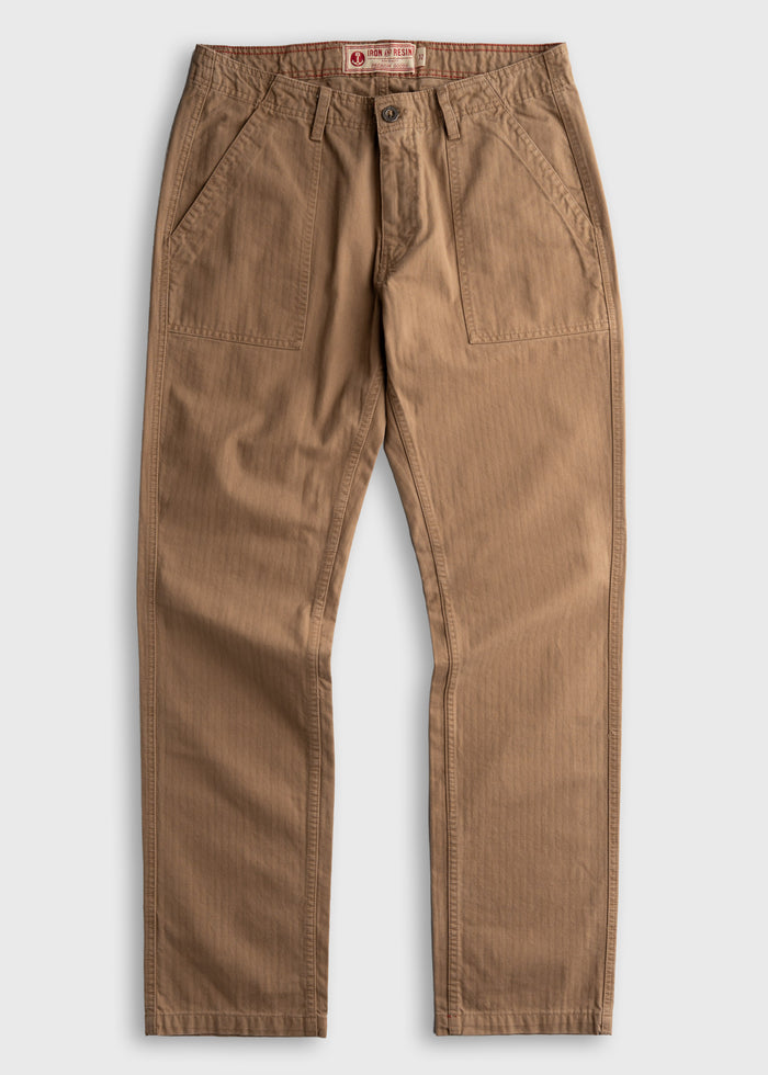 Brown Iron & Resin pants with front pockets and button closure, displayed flat on a white background, showcasing casual style.