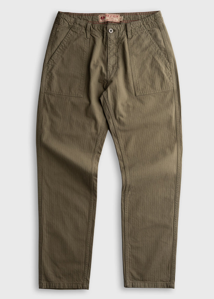 Olive green pants with front pockets and button closure, laid flat on a white background. Iron & Resin label visible inside.