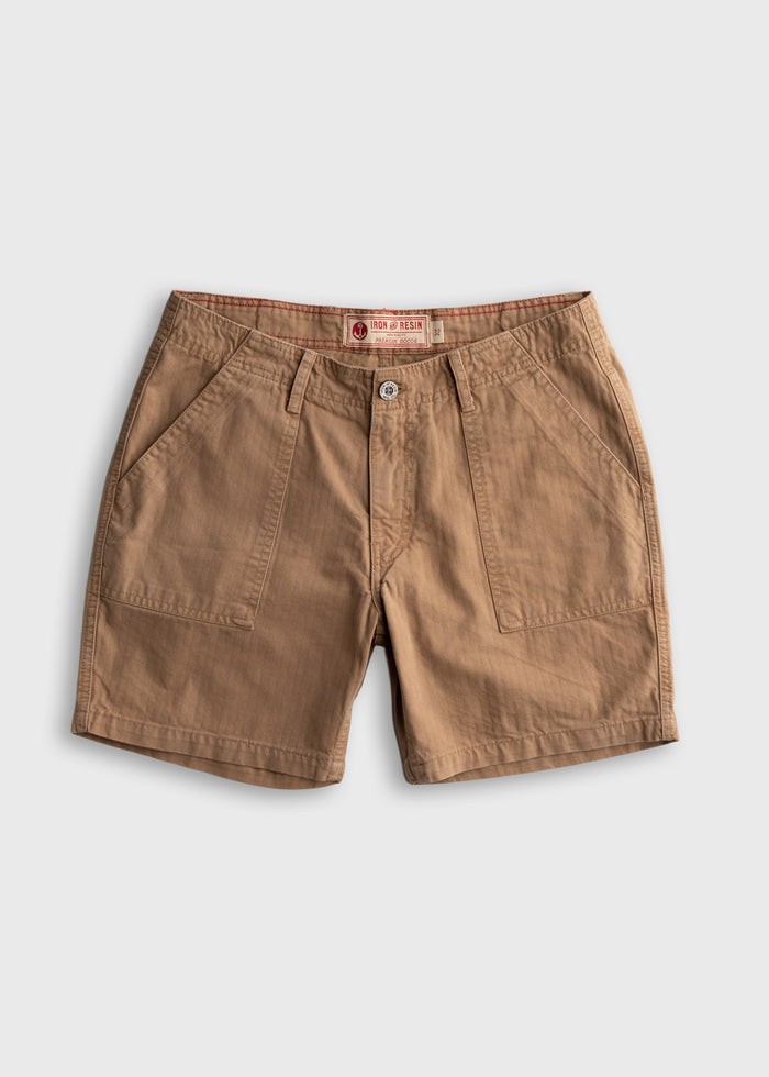Brown cotton shorts with front pockets, button closure, and branded label, displayed on a white background. Casual style.