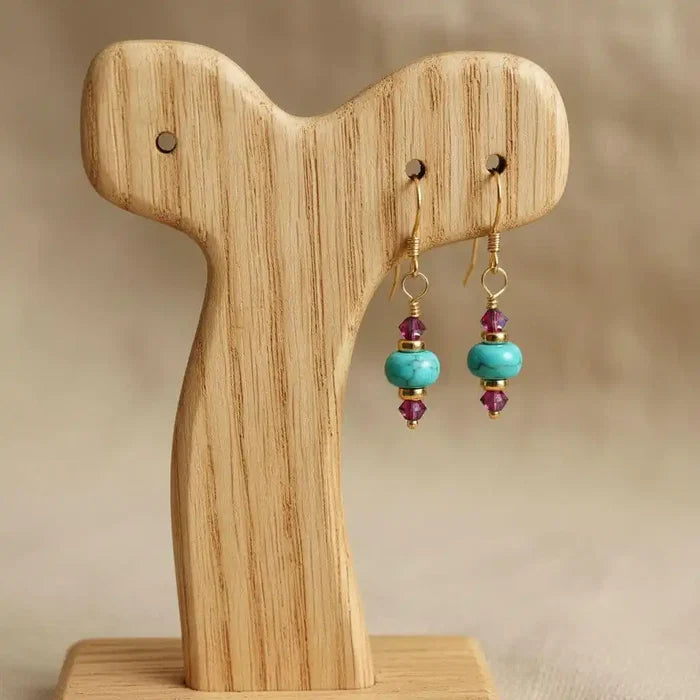 Hot Pink and Turquoise Gemstone14 K Gold Filled Earrings displayed on a wooden stand, showcasing vibrant colors and elegant design.