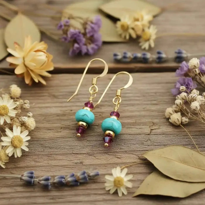 Hot Pink and Turquoise Gemstone14 K Gold Filled Earrings displayed among dried flowers.