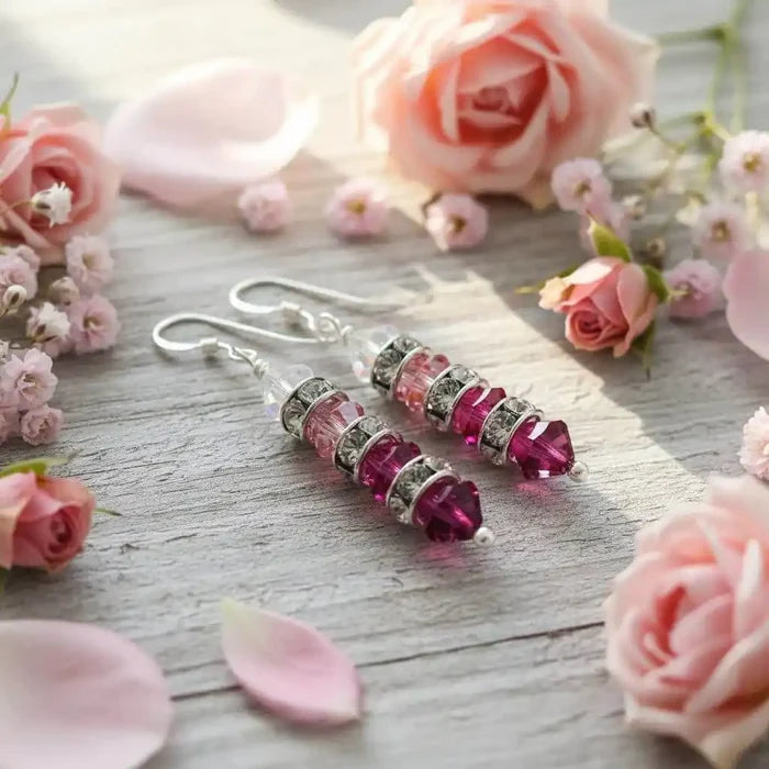 Hot Pink Ombre Stacked Crystal Sterling Silver Earrings showcased among delicate pink roses and petals.