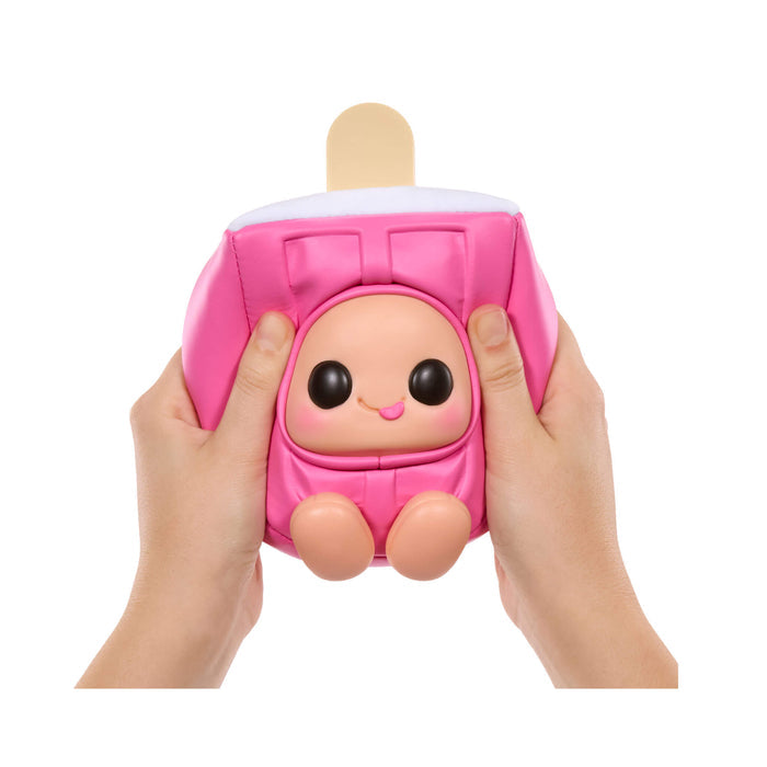 Pink plush toy resembling a popsicle on a stick held by two hands against a white background