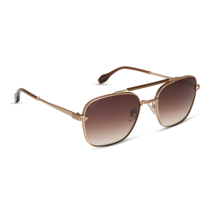 diff eyewear x stephen wilson jr. i'm a song navigator sunglasses with a gold metal frame and brown gradient lenses angled view