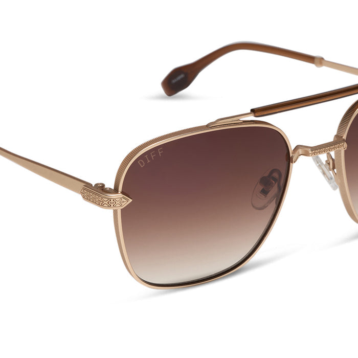 diff eyewear x stephen wilson jr. i'm a song navigator sunglasses with a gold metal frame and brown gradient lenses detailed view