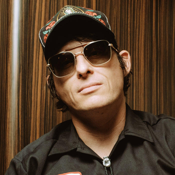 lifestyle - diff eyewear with stephen wilson jr. wearing i'm a song navigator sunglasses with a gold metal frame and brown gradient lenses in a music studio