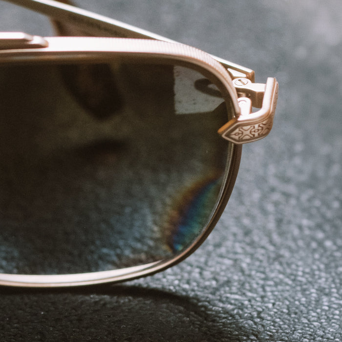 still life - diff eyewear x stephen wilson jr.  i'm a song navigator sunglasses with a gold metal frame and brown gradient lenses detailed temple view