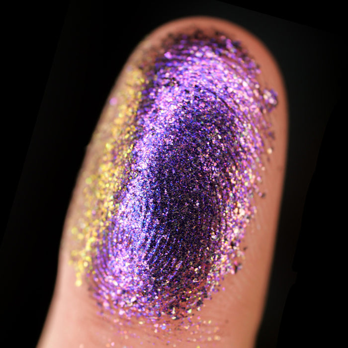 Macro finger swatch of Ion Dimensional Multichrome Eyeshadow on fair skin tone.