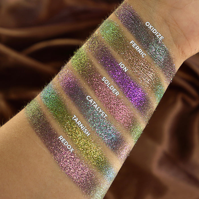 Arm swatches of Oxidize, Ferric, Ion, Solder, Catalyst, Tarnish and Redox on medium skin tone.
