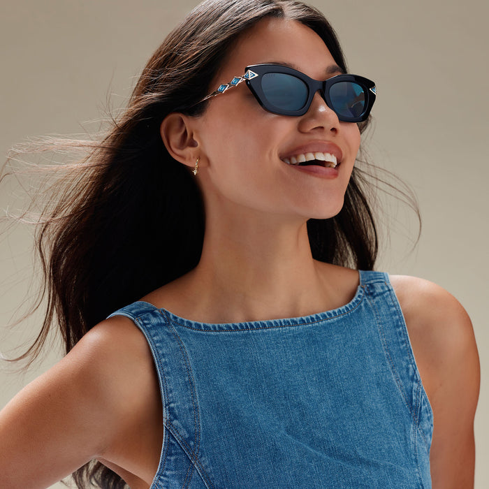 lifestyle - female wearing diff eyewear x disney princess featuring the jasmine 2.0 cateye sunglasses with a black acetate frame and teal lenses angled view
