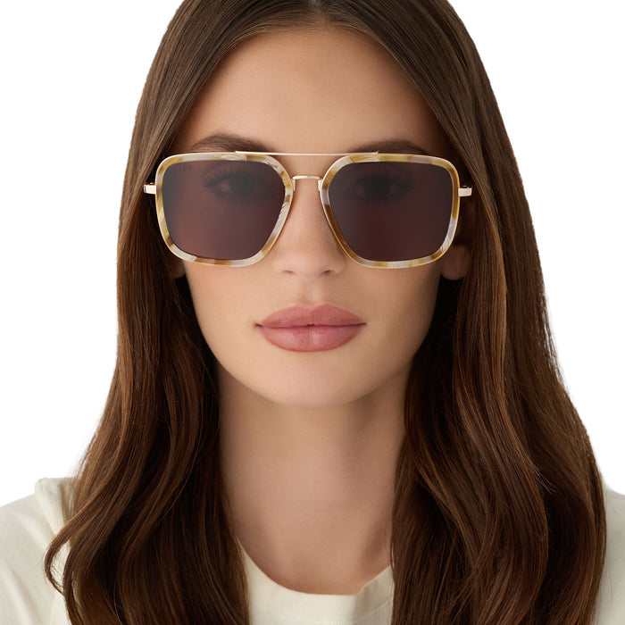 on model - female wearing diff eyewear jordan navigator sunglasses with a gilded tortoise acetate and gold metal frame with a brown lens front view
