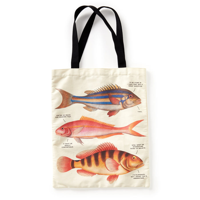 The Brass Monkey Judgy Fish Canvas Tote is a cream tote bag with black handles, showcasing three vintage-style, colorful fish illustrations, each labeled with fine black text.