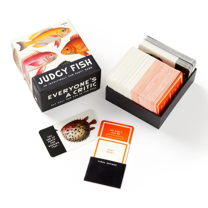 Judgy Fish Game by Brass Monkey is a hilarious party and insult game with illustrated fish on the box and colorful cards like YOUR TEAM IS ARGUING and DARK HUMOR for endless laughs.