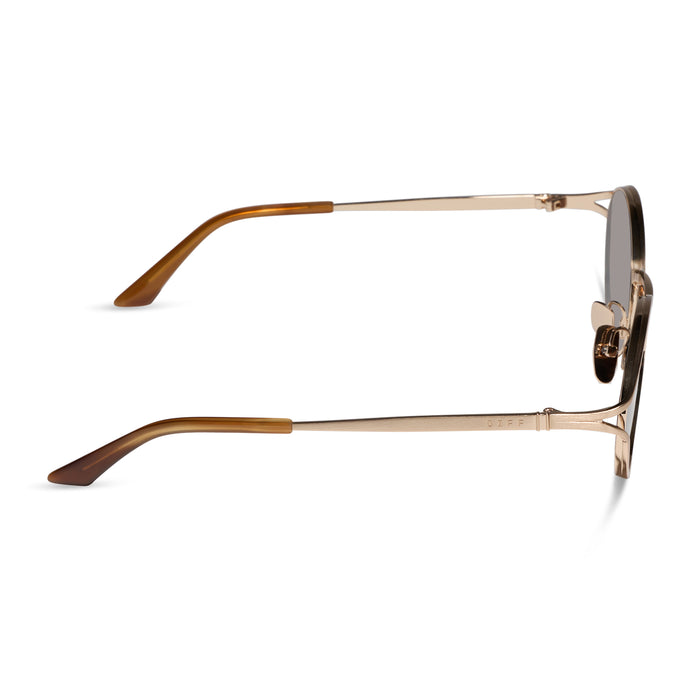 diff eyewear featuring the juliette round sunglasses with a brush gold metal frame and truffle brown polarized lenses side view