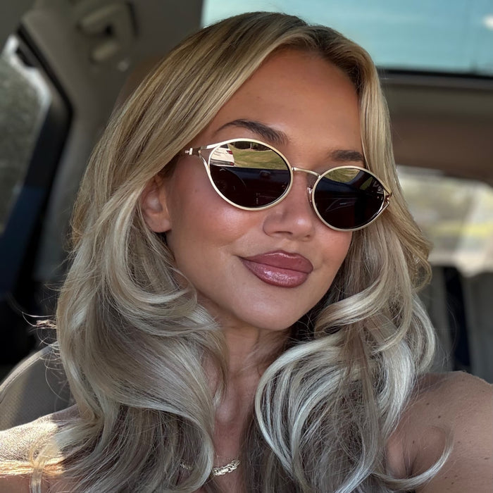 lifestyle - ashley smith wearing gold metal oval frame diff sunglasses