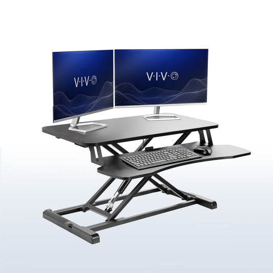Sturdy height adjustable 2-tiered desk riser for ergonomic office workstation in  office setting.